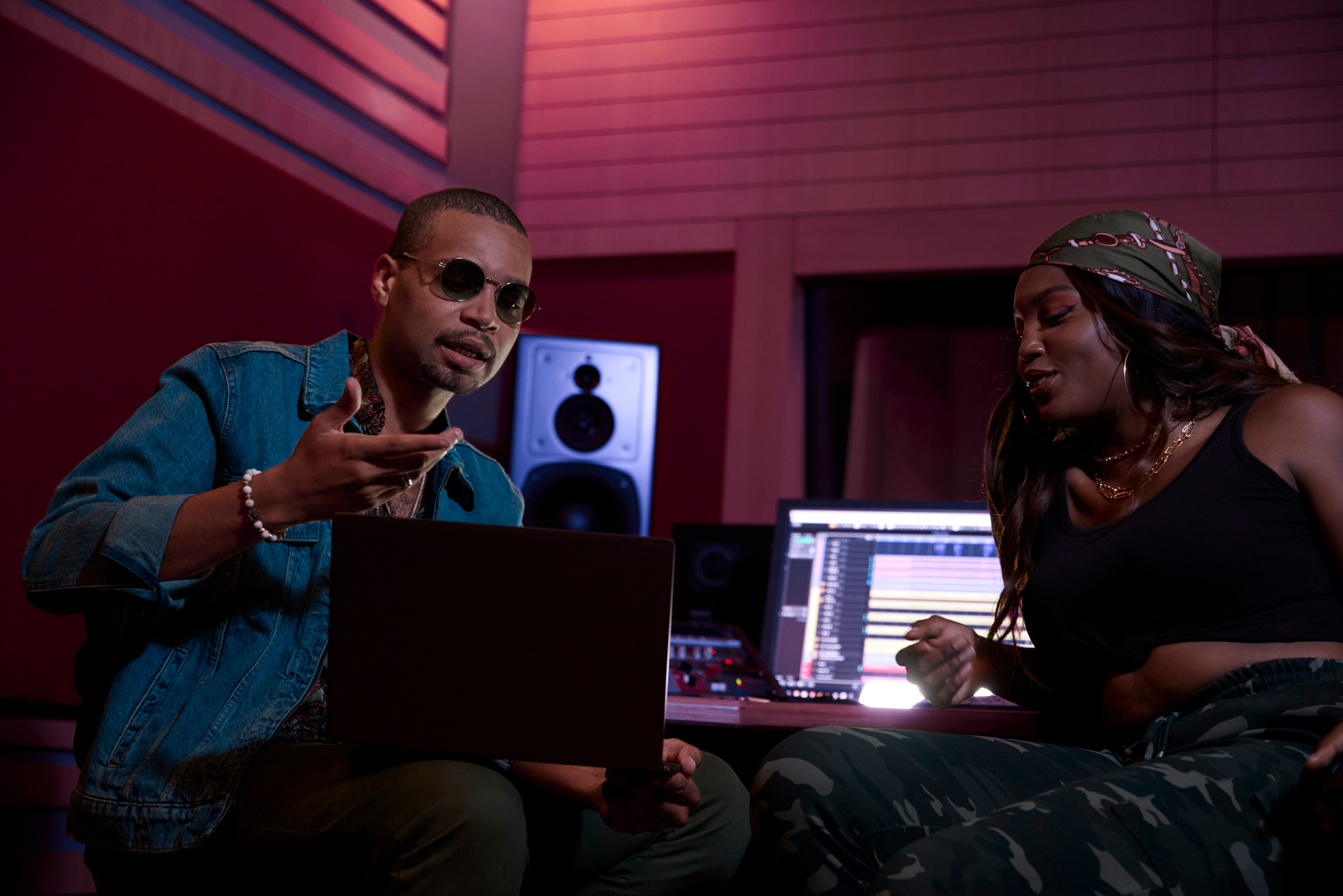 African-american female singer consulting with music producer about releasing album in music studio